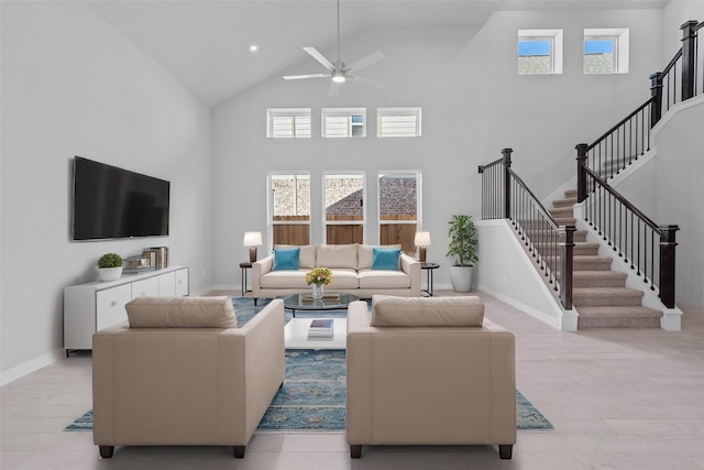 2008 Sugarberry Gully Ln, Conroe, TX 77301 - living area with high vaulted ceiling, a ceiling fan, plenty of natural light, stairs, and baseboards