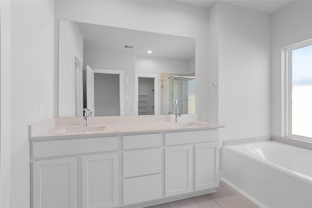 2008 Sugarberry Gully Ln, Conroe, TX 77301 - full bath with a shower stall, double vanity, a bath, and recessed lighting