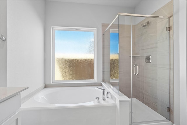 2008 Sugarberry Gully Ln, Conroe, TX 77301 - bathroom with healthy amount of natural light, a garden tub, and a shower stall