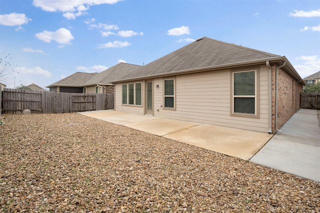 24018 Adobe Ridge Ln, Katy, TX 77493 - rear view of house featuring a fenced backyard, a patio, and brick siding