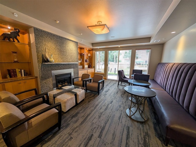 3505 Sage Rd Unit 1809, Houston, TX 77056 - living area featuring wood finished floors, a fireplace, built in shelves, and a raised ceiling