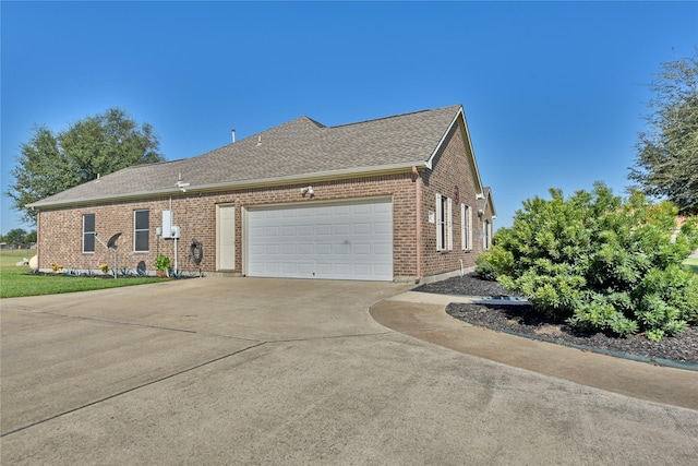 3077 Dees Cir, Sealy, TX 77474 - view of home's exterior with brick siding, concrete driveway, an attached garage, and roof with shingles