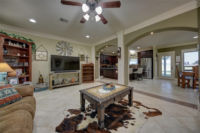 3077 Dees Cir, Sealy, TX 77474 - living room with arched walkways, light tile patterned flooring, ceiling fan, ornamental molding, and recessed lighting