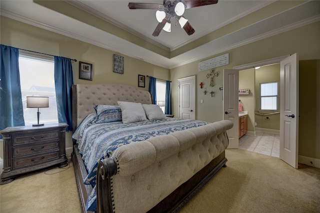 3077 Dees Cir, Sealy, TX 77474 - bedroom featuring light carpet, crown molding, a raised ceiling, ensuite bath, and baseboards