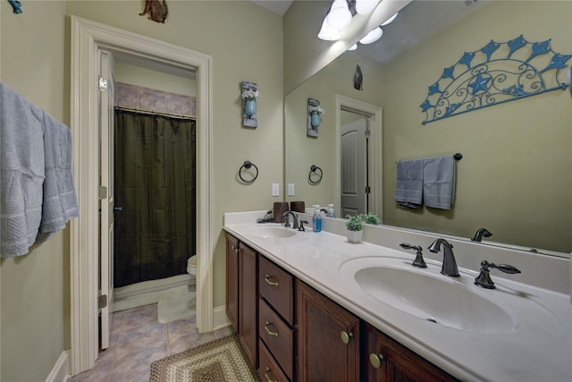 3077 Dees Cir, Sealy, TX 77474 - full bathroom featuring double vanity, toilet, tile patterned flooring, and curtained shower