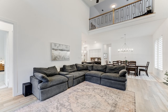 4222 Ana Ridge Ln, Fulshear, TX 77441 - living area with a chandelier, wood finished floors, and a high ceiling