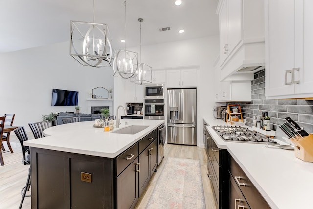 4222 Ana Ridge Ln, Fulshear, TX 77441 - kitchen with stainless steel appliances, a sink, a chandelier, light countertops, and recessed lighting