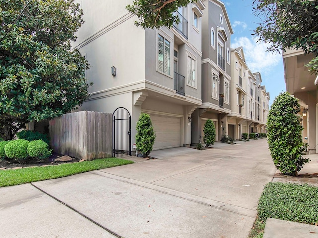 4133 Dickson St, Houston, TX 77007 - view of building exterior featuring an attached garage and driveway