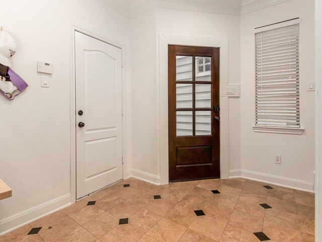 4133 Dickson St, Houston, TX 77007 - entrance foyer featuring baseboards, light tile patterned floors, and crown molding