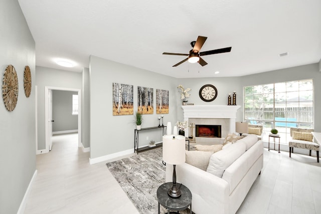 2019 Teakwood Pl, Sugar Land, TX 77478 - living area featuring ceiling fan, baseboards, a high end fireplace, and light wood-style floors