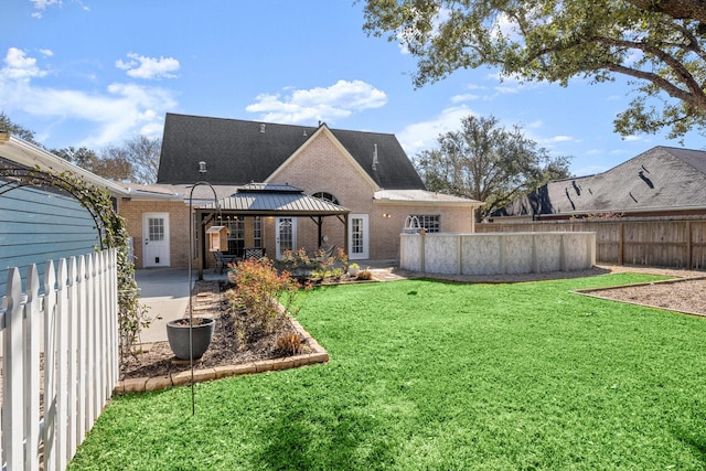 3233 Greenhead St, Katy, TX 77493 - rear view of property featuring brick siding, a gazebo, a patio, and roof with shingles
