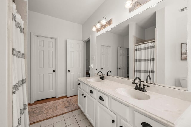 3233 Greenhead St, Katy, TX 77493 - bathroom featuring double vanity, tile patterned floors, toilet, and a shower with curtain