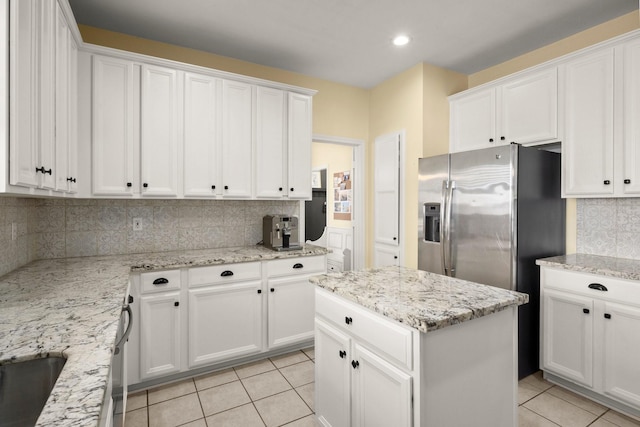 3233 Greenhead St, Katy, TX 77493 - kitchen with light tile patterned flooring, backsplash, white cabinetry, a center island, and recessed lighting