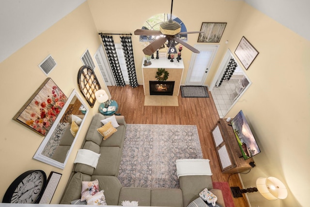 3233 Greenhead St, Katy, TX 77493 - living room featuring ceiling fan, wood finished floors, and a tile fireplace