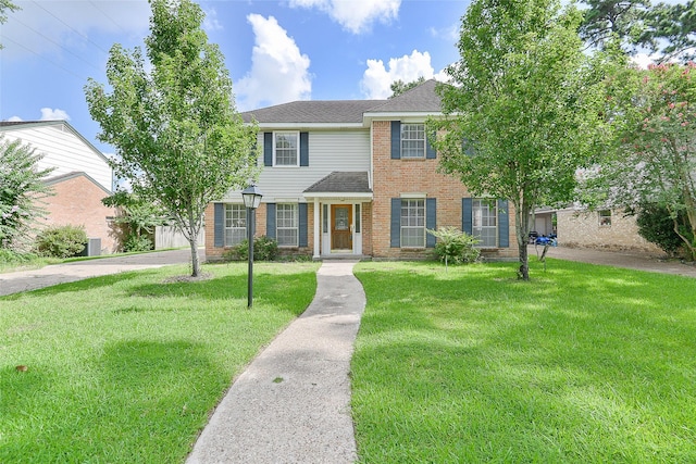 5411 Mossy Timbers Dr, Humble, TX 77346 - view of front of home with a front lawn, brick siding, and a shingled roof