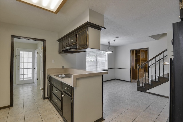 5411 Mossy Timbers Dr, Humble, TX 77346 - kitchen featuring black electric stovetop, light tile patterned floors, plenty of natural light, light countertops, and a textured ceiling