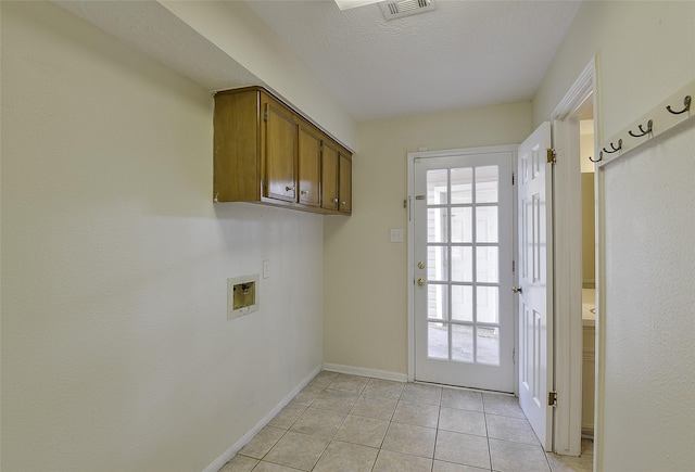 5411 Mossy Timbers Dr, Humble, TX 77346 - washroom featuring washer hookup, cabinet space, light tile patterned floors, and a textured ceiling