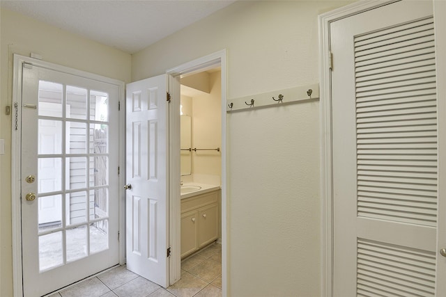 5411 Mossy Timbers Dr, Humble, TX 77346 - doorway to outside with light tile patterned floors and a sink