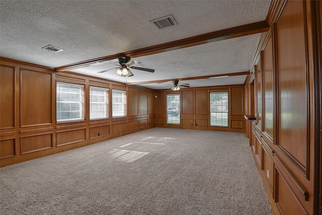 5411 Mossy Timbers Dr, Humble, TX 77346 - empty room with a textured ceiling, a decorative wall, a ceiling fan, and light carpet