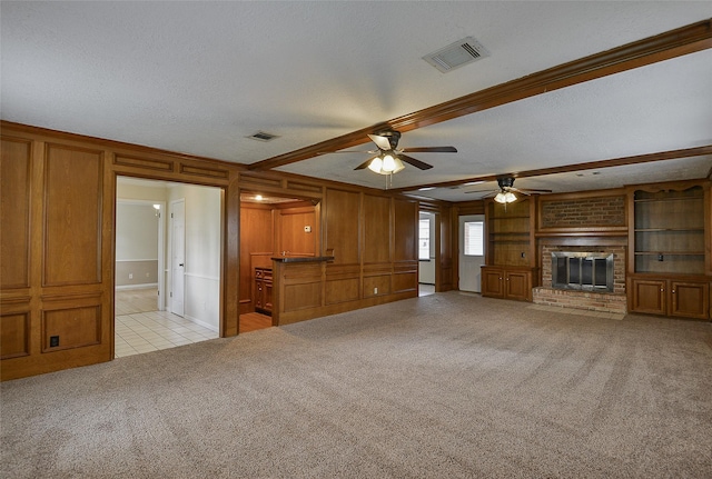 5411 Mossy Timbers Dr, Humble, TX 77346 - unfurnished living room with light carpet, ceiling fan, a textured ceiling, light tile patterned floors, and wooden walls