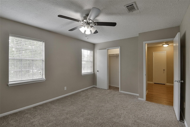 5411 Mossy Timbers Dr, Humble, TX 77346 - unfurnished bedroom featuring light colored carpet, a textured ceiling, ceiling fan, and a closet