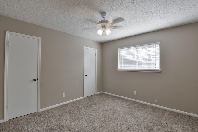 5411 Mossy Timbers Dr, Humble, TX 77346 - unfurnished bedroom featuring carpet flooring, a textured ceiling, and a ceiling fan