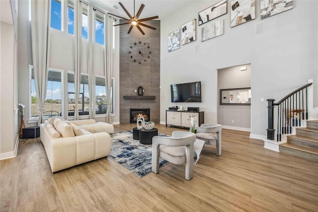 21310 Blue Wood Aster Ct, Cypress, TX 77433 - living room with a towering ceiling, stairway, wood finished floors, baseboards, and a ceiling fan