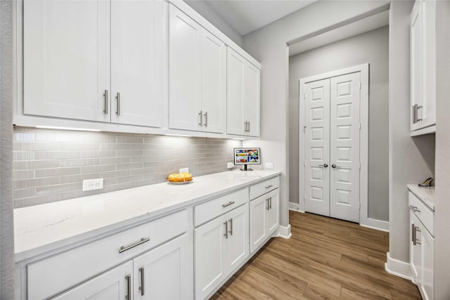 21310 Blue Wood Aster Ct, Cypress, TX 77433 - kitchen with light wood-style floors, white cabinets, backsplash, and baseboards