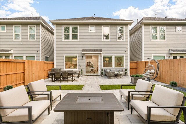 4926 Wunder Way, Houston, TX 77069 - rear view of property featuring an outdoor living space with a fire pit, a patio, and a fenced backyard