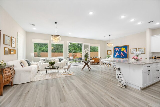 4926 Wunder Way, Houston, TX 77069 - living room with a chandelier, light wood-style floors, and recessed lighting