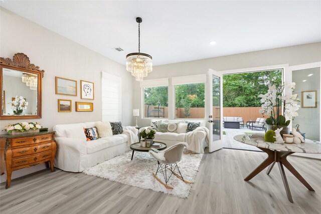 4926 Wunder Way, Houston, TX 77069 - living area with light wood finished floors, a chandelier, healthy amount of natural light, and recessed lighting