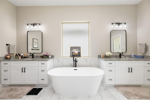 4926 Wunder Way, Houston, TX 77069 - full bath featuring marble look tile flooring, two vanities, a freestanding bath, a wainscoted wall, and tile walls