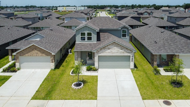12327 Lariat Run Dr, Houston, TX 77014 - view of front facade featuring a shingled roof, driveway, and a residential view