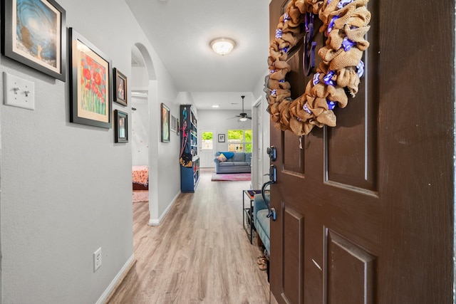 12218 Estelle Ln, Pinehurst, TX 77362 - hallway featuring light wood finished floors and arched walkways