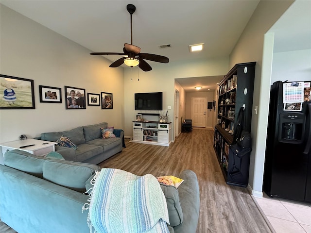 12218 Estelle Ln, Pinehurst, TX 77362 - living room with light wood finished floors, a ceiling fan, and baseboards