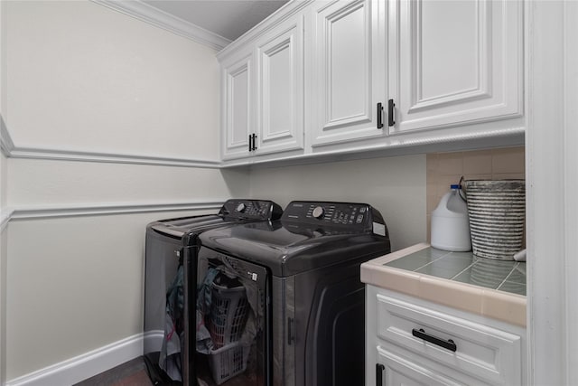 12219 W River Run Dr, Baytown, TX 77523 - washroom featuring cabinet space, washing machine and dryer, and ornamental molding