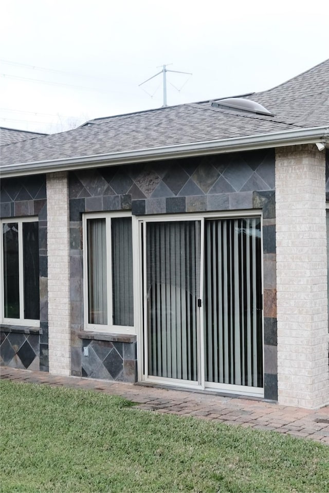 2217 W Reata Dr, Deer Park, TX 77536 - back of property featuring a shingled roof and brick siding