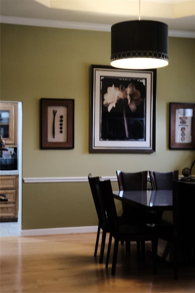 2217 W Reata Dr, Deer Park, TX 77536 - dining area featuring wood finished floors, ornamental molding, and baseboards