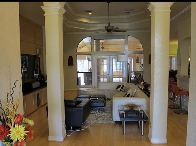 2217 W Reata Dr, Deer Park, TX 77536 - living room with ornate columns, wood finished floors, crown molding, and a ceiling fan