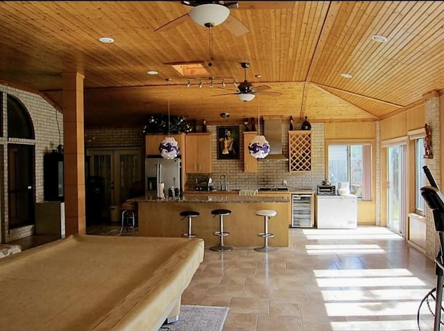 2217 W Reata Dr, Deer Park, TX 77536 - kitchen with stainless steel fridge with ice dispenser, wood ceiling, a ceiling fan, beverage cooler, and a center island