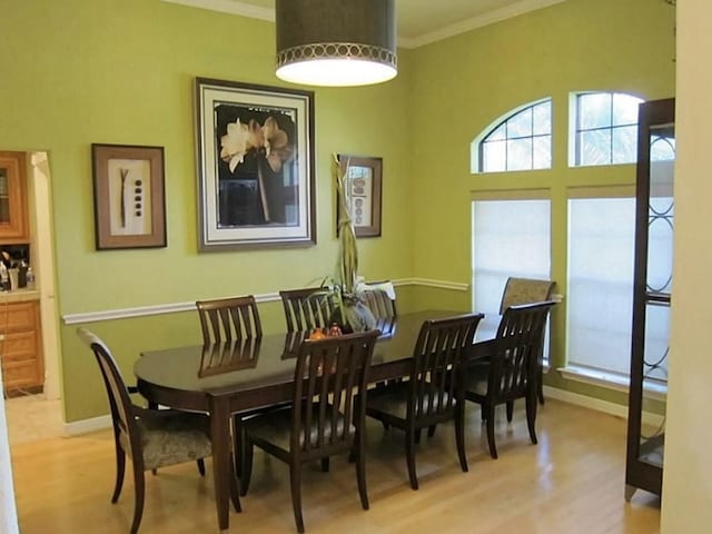 2217 W Reata Dr, Deer Park, TX 77536 - dining space with plenty of natural light, crown molding, wood finished floors, and baseboards