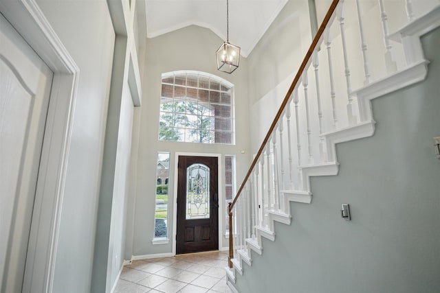 14522 Belvan Ct, Cypress, TX 77429 - entrance foyer with high vaulted ceiling, a chandelier, light tile patterned flooring, baseboards, and stairs