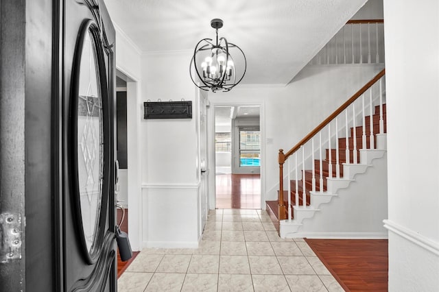 3602 Highland Lakes Dr, Kingwood, TX 77339 - entryway with a chandelier, stairs, and ornamental molding
