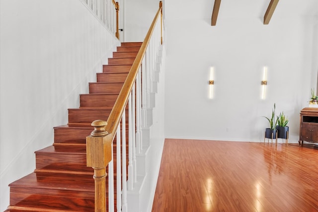 3602 Highland Lakes Dr, Kingwood, TX 77339 - stairs featuring wood finished floors and beamed ceiling