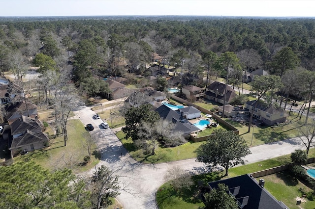 3602 Highland Lakes Dr, Kingwood, TX 77339 - aerial view of property's location with a heavily wooded area, a pool, and nearby suburban area