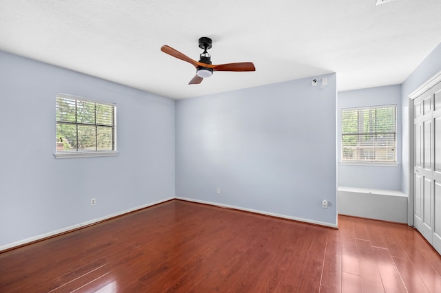 3602 Highland Lakes Dr, Kingwood, TX 77339 - empty room with plenty of natural light, wood finished floors, ceiling fan, and baseboards