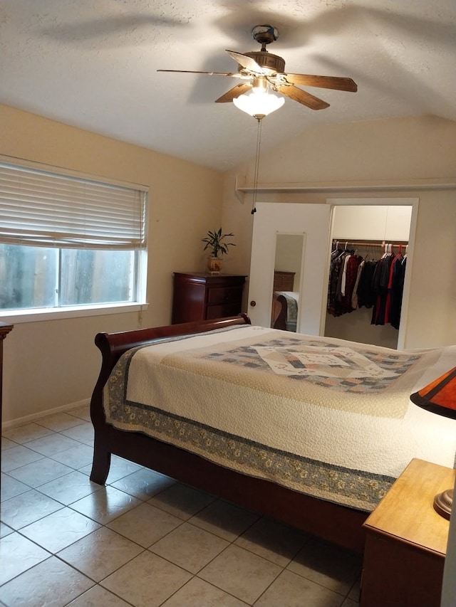 2450 Edgedale Dr, Missouri City, TX 77489 - bedroom with lofted ceiling, a closet, light tile patterned flooring, and a ceiling fan