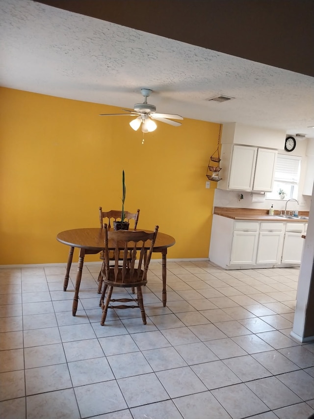 2450 Edgedale Dr, Missouri City, TX 77489 - dining area featuring light tile patterned floors, a textured ceiling, and a ceiling fan