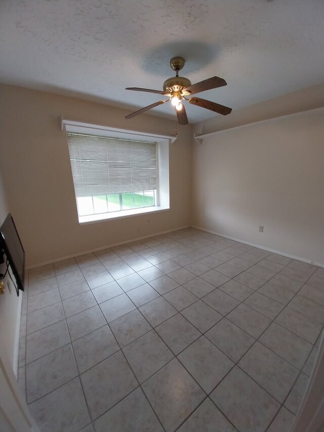2450 Edgedale Dr, Missouri City, TX 77489 - spare room with a ceiling fan, light tile patterned flooring, and a textured ceiling