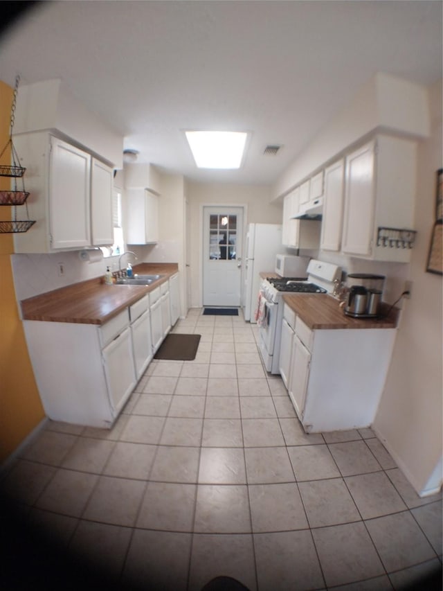 2450 Edgedale Dr, Missouri City, TX 77489 - kitchen with white appliances, butcher block counters, light tile patterned flooring, under cabinet range hood, and white cabinets